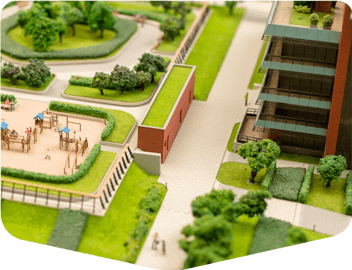 Imagen que ilustra una comunidad bien planificada con zonas verdes, áreas para niños, y el conjunto habitacional